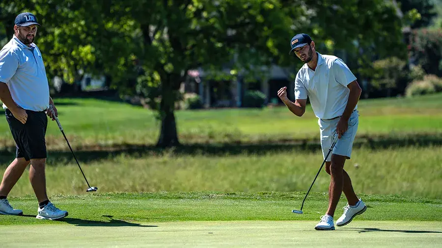 two male golfers one doing fist pump